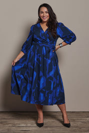 Model Ashleigh wearing size 16 of the Belle Puff Sleeve Printed  Cotton Wrap Dress in colour Trioofblue (Blue), from the front, showing the whole outfit