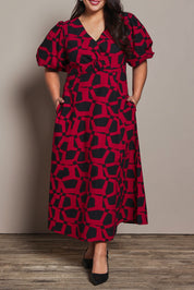 Model Ashleigh wearing size 16 of the Belle Printed Twist Knot Detail Cotton Dress in colour Blackrasp (Black), from the front, cropped image