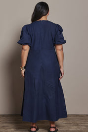 Model Ashleigh wearing size 16 of the Belle Twist Knot Detail Cotton Dress in colour Darknavy (Blue), from the back