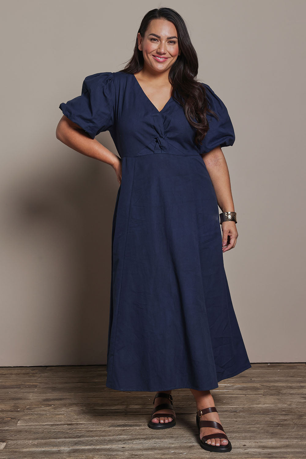 Model Ashleigh wearing size 16 of the Belle Twist Knot Detail Cotton Dress in colour Darknavy (Blue), from the front, showing the whole outfit
