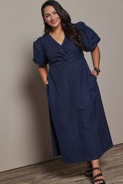 Model Ashleigh wearing size 16 of the Belle Twist Knot Detail Cotton Dress in colour Darknavy (Blue), from the front, showing the whole outfit