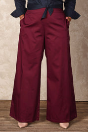 Model Ashleigh wearing size 16 of the Belle Cotton Comfort Wide Leg Pant in colour Burgundy (Purple), from the front, cropped image