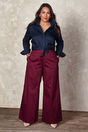Model Ashleigh wearing size 16 of the Belle Cotton Comfort Wide Leg Pant in colour Burgundy (Purple), from the front, showing the whole outfit