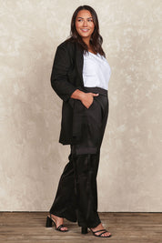 Model Jane wearing size 16 of the Belle Pull On Satin Cargo Pants in colour Black (Black), from the front, showing the whole outfit