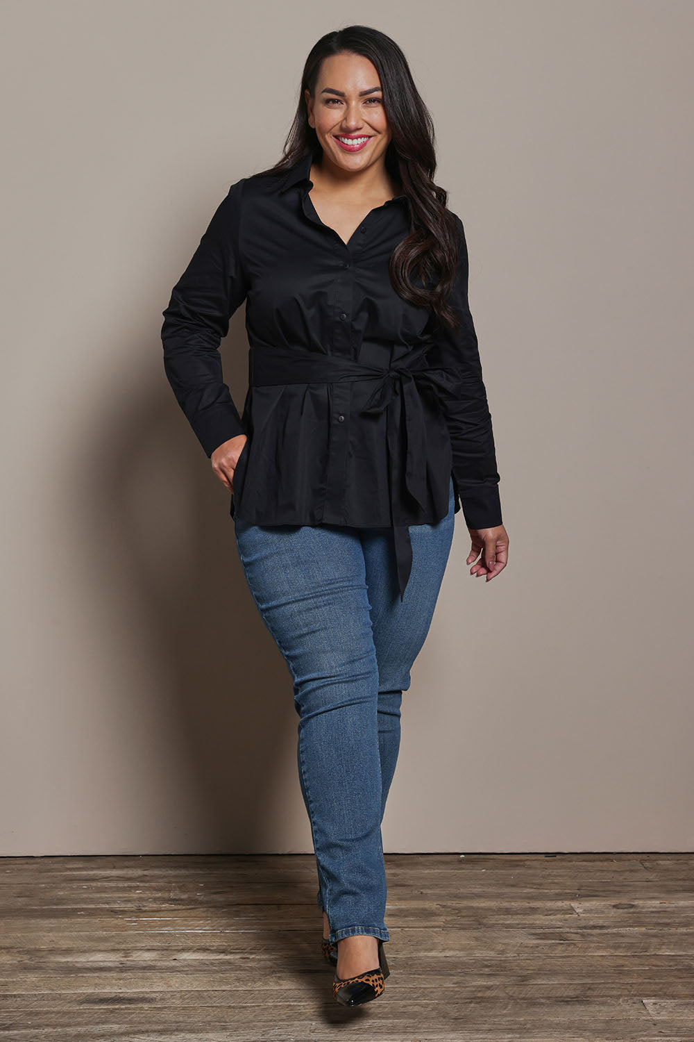 Model Ashleigh wearing size 16 of the Belle Tie Waist Cotton Shirt in colour Black (Black), from the front, showing the whole outfit