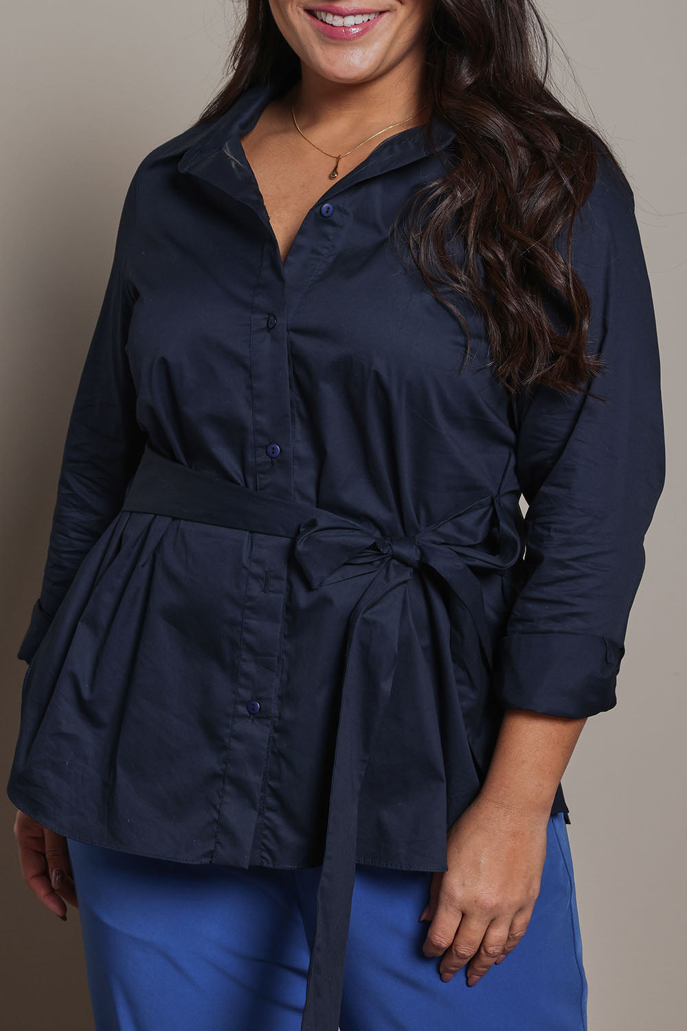 Model Ashleigh wearing size 16 of the Belle Tie Waist Cotton Shirt in colour Navy (Blue), from the front, cropped image