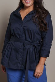 Model Ashleigh wearing size 16 of the Belle Tie Waist Cotton Shirt in colour Navy (Blue), from the front, cropped image