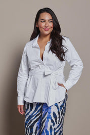 Model Ashleigh wearing size 16 of the Belle Tie Waist Cotton Shirt in colour White (White), from the front, cropped image