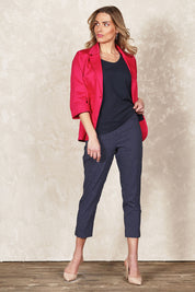 Model Olivia wearing size 10 of the Belle Printed Slim Pant in colour Navyspot (Blue), from the front, showing the whole outfit