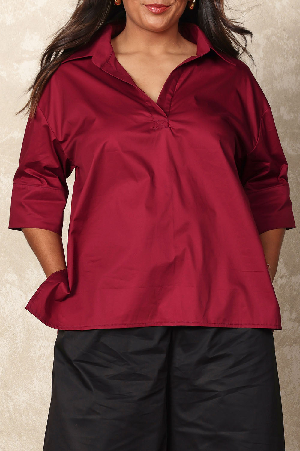 Model Ashleigh wearing size 16 of the Belle Easy Cotton Pop Over Top in colour Chillired (Red), from the front, cropped image