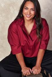 Model Ashleigh wearing size 16 of the Belle Easy Cotton Pop Over Top in colour Chillired (Red), from the front, showing the whole outfit