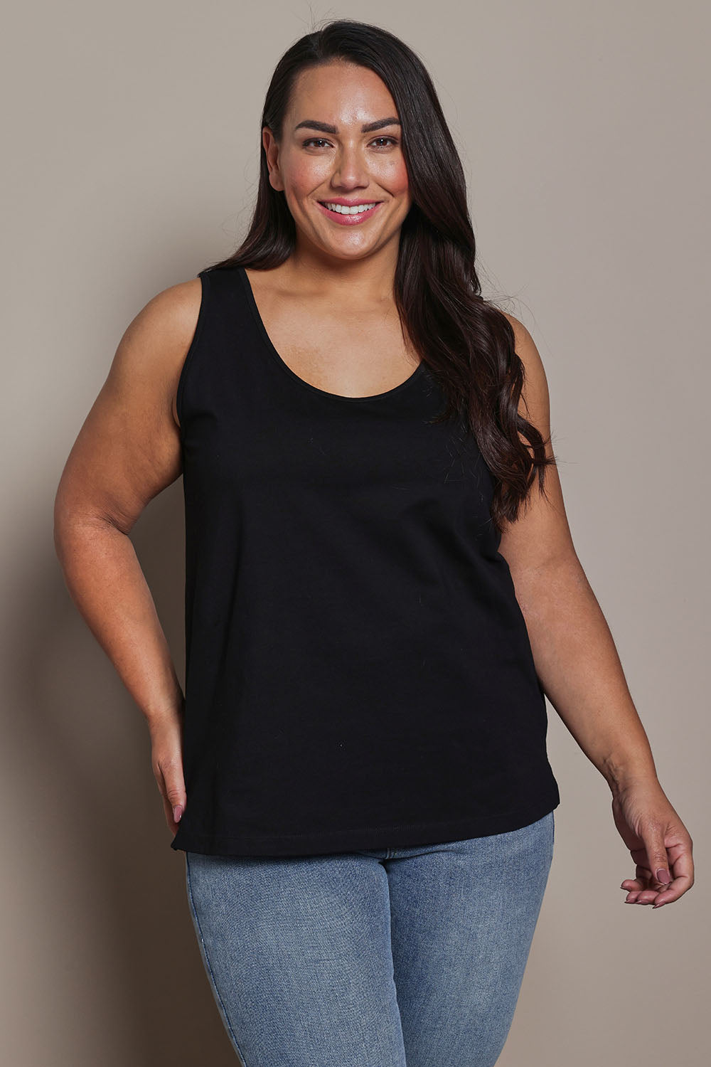 Model Ashleigh wearing size 16 of the Belle Luxe Cotton Tank in colour Black (Black), from the front, cropped image