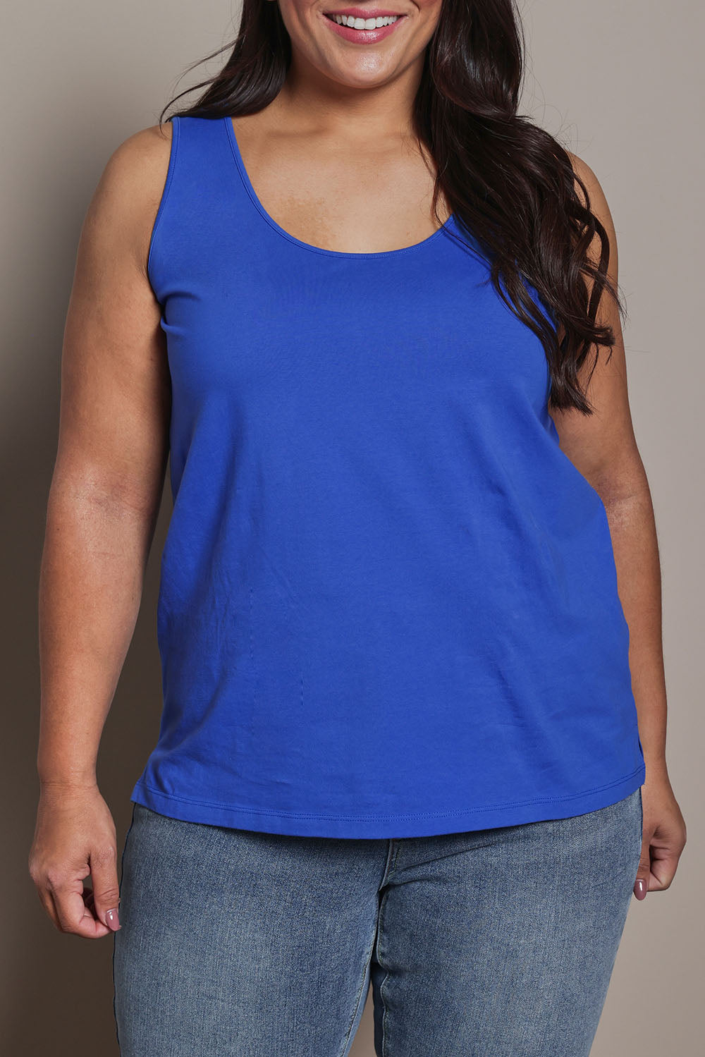 Model Ashleigh wearing size 16 of the Belle Luxe Cotton Tank in colour Seablue (Blue), from the front, cropped image