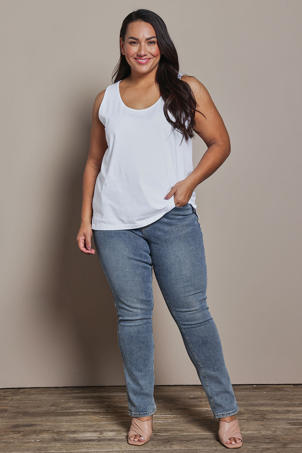 Model Ashleigh wearing size 16 of the Belle Luxe Cotton Tank in colour White (White), from the front, showing the whole outfit