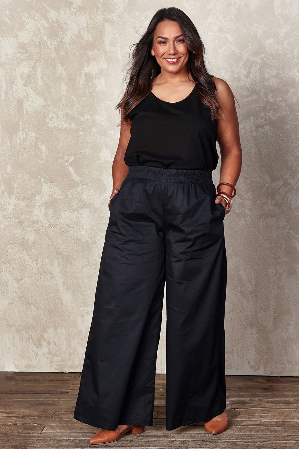 Model Ashleigh wearing size 16 of the Belle Cotton Palazzo Pant in colour Black (Black), from the front, showing the whole outfit