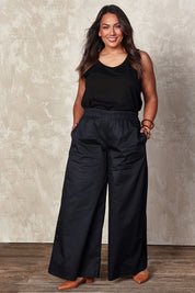 Model Ashleigh wearing size 16 of the Belle Cotton Palazzo Pant in colour Black (Black), from the front, showing the whole outfit