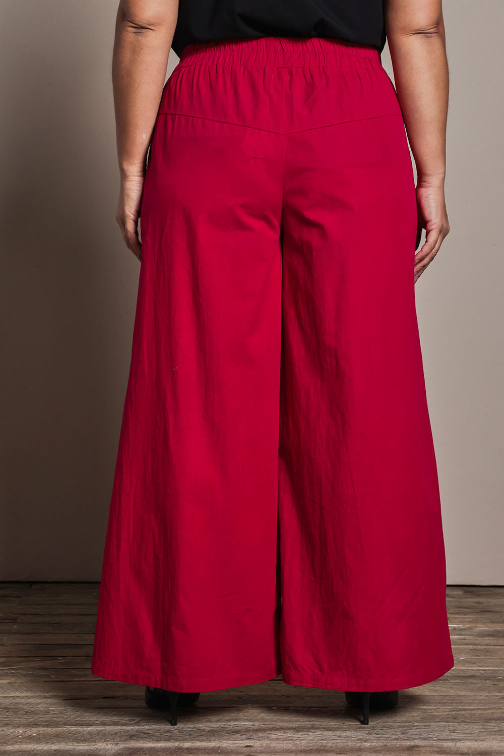 Model Ashleigh wearing size 16 of the Belle Cotton Palazzo Pant in colour Raspberry (Red), from the back