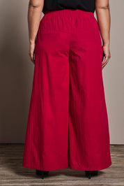 Model Ashleigh wearing size 16 of the Belle Cotton Palazzo Pant in colour Raspberry (Red), from the back