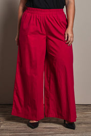 Model Ashleigh wearing size 16 of the Belle Cotton Palazzo Pant in colour Raspberry (Red), from the front, cropped image