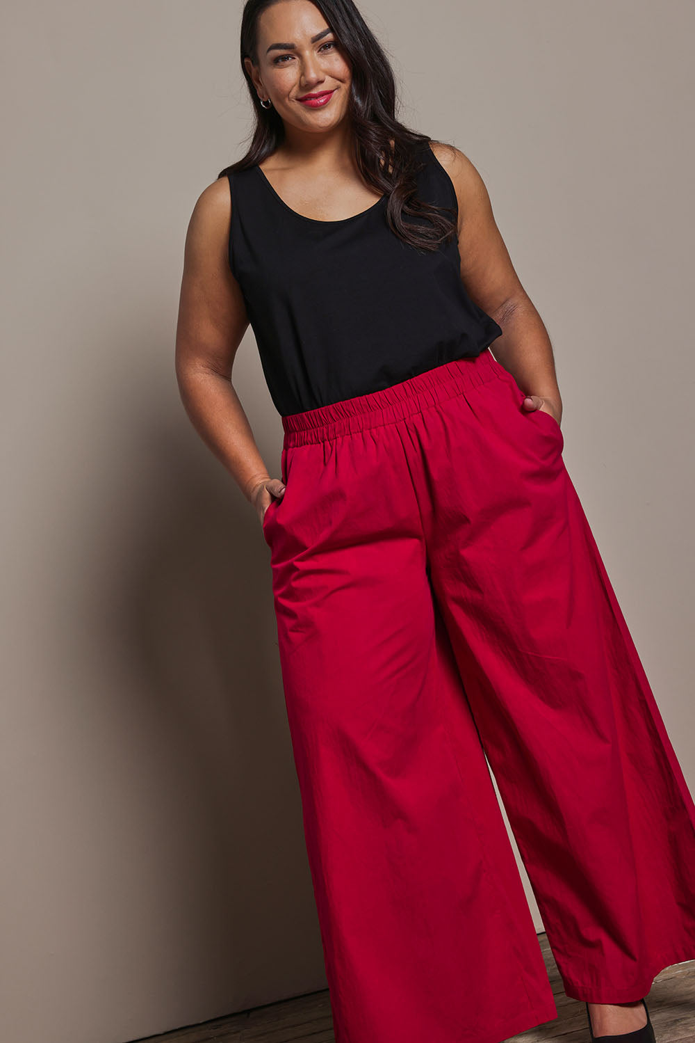 Model Ashleigh wearing size 16 of the Belle Cotton Palazzo Pant in colour Raspberry (Red), from the front, showing the whole outfit