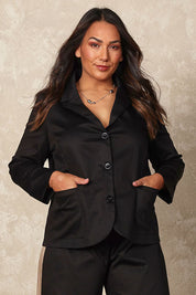 Model Ashleigh wearing size 16 of the Belle Button Up Cotton Stretch  Blazer in colour Black (Black), from the front, showing the whole outfit