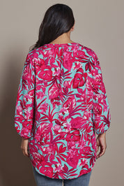 Model Ashleigh wearing size 16 of the Belle Printed Full Sleeve Shirt in colour Aquafusch (Pink), from the back
