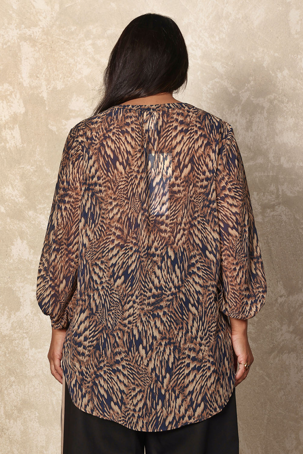 Model Ashleigh wearing size 16 of the Belle Printed Full Sleeve Shirt in colour Blacksand (Black), from the back