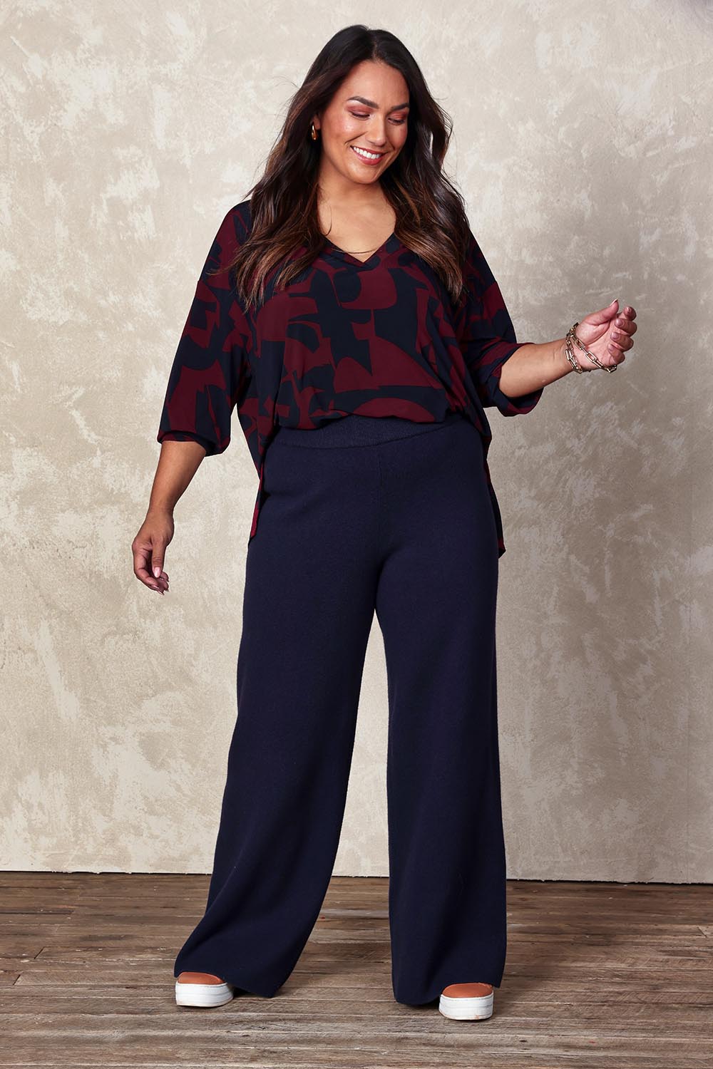 Model Ashleigh wearing size XL of the Belle Cosy Knit Pull On Wide Leg Pants in colour Navy (Blue), from the front, showing the whole outfit