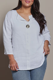 Model Ashleigh wearing size 16 of the Belle High Low Linen Top in colour White (White), from the front, cropped image
