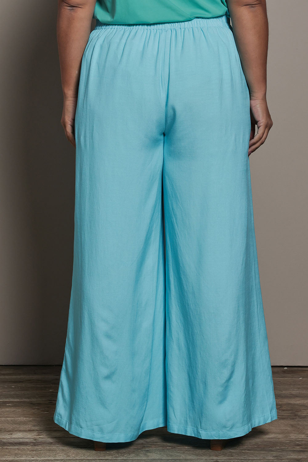 Model Ashleigh wearing size 16 of the Belle Pull On Palazzo Pants With Pockets in colour Aqua (Blue), from the back
