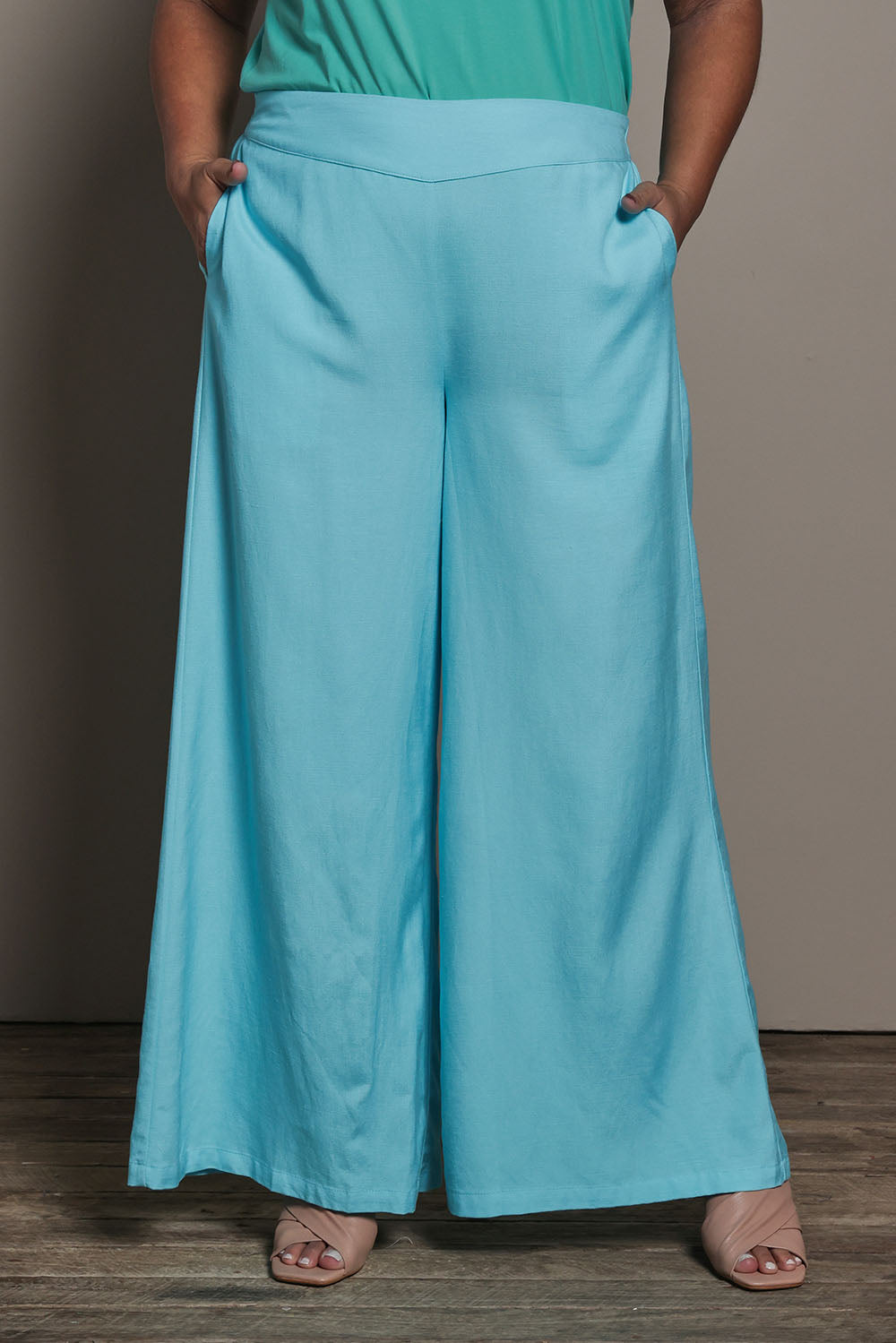 Model Ashleigh wearing size 16 of the Belle Pull On Palazzo Pants With Pockets in colour Aqua (Blue), from the front, cropped image