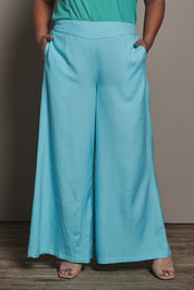 Model Ashleigh wearing size 16 of the Belle Pull On Palazzo Pants With Pockets in colour Aqua (Blue), from the front, cropped image