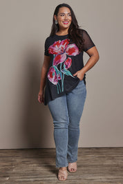 Model Ashleigh wearing size 16 of the Belle Printed Mesh Asymmetric Tee in colour Blackfleur (Black), from the front, showing the whole outfit