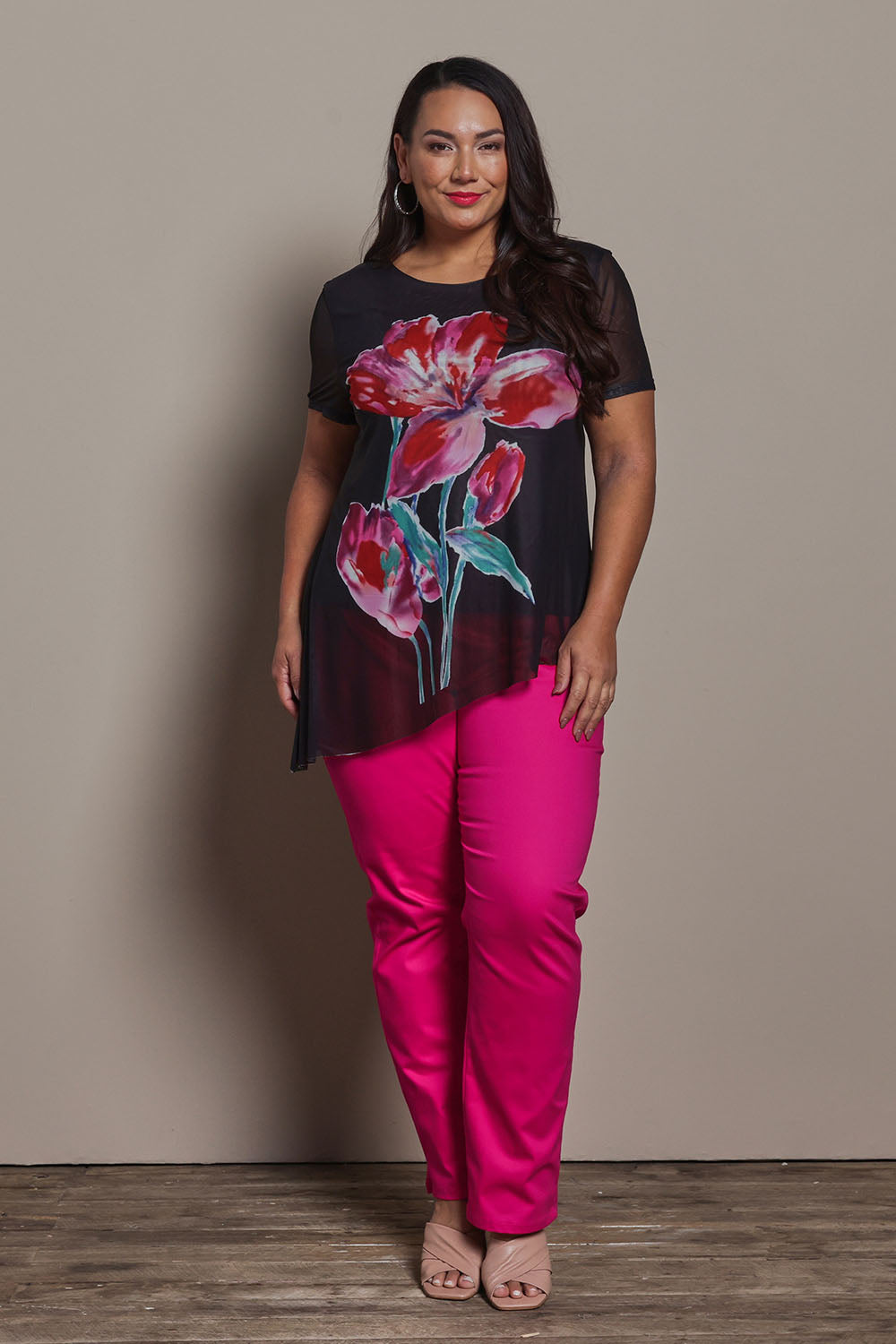 Model Ashleigh wearing size 16 of the Belle Printed Mesh Asymmetric Tee in colour Blackfleur (Black), from the front, showing the whole outfit