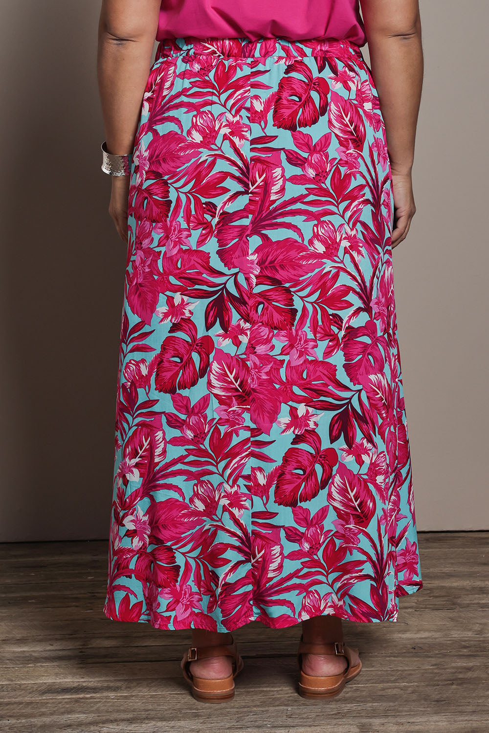 Model Ashleigh wearing size 16 of the Belle Printed Pull On Full Skirt with Pockets in colour Aquafusch (Pink), from the back