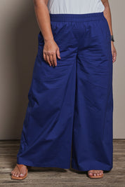 Model Ashleigh wearing size 16 of the Belle Cotton Stretch Palazzo Pant in colour Sapphire (Blue), from the front, cropped image