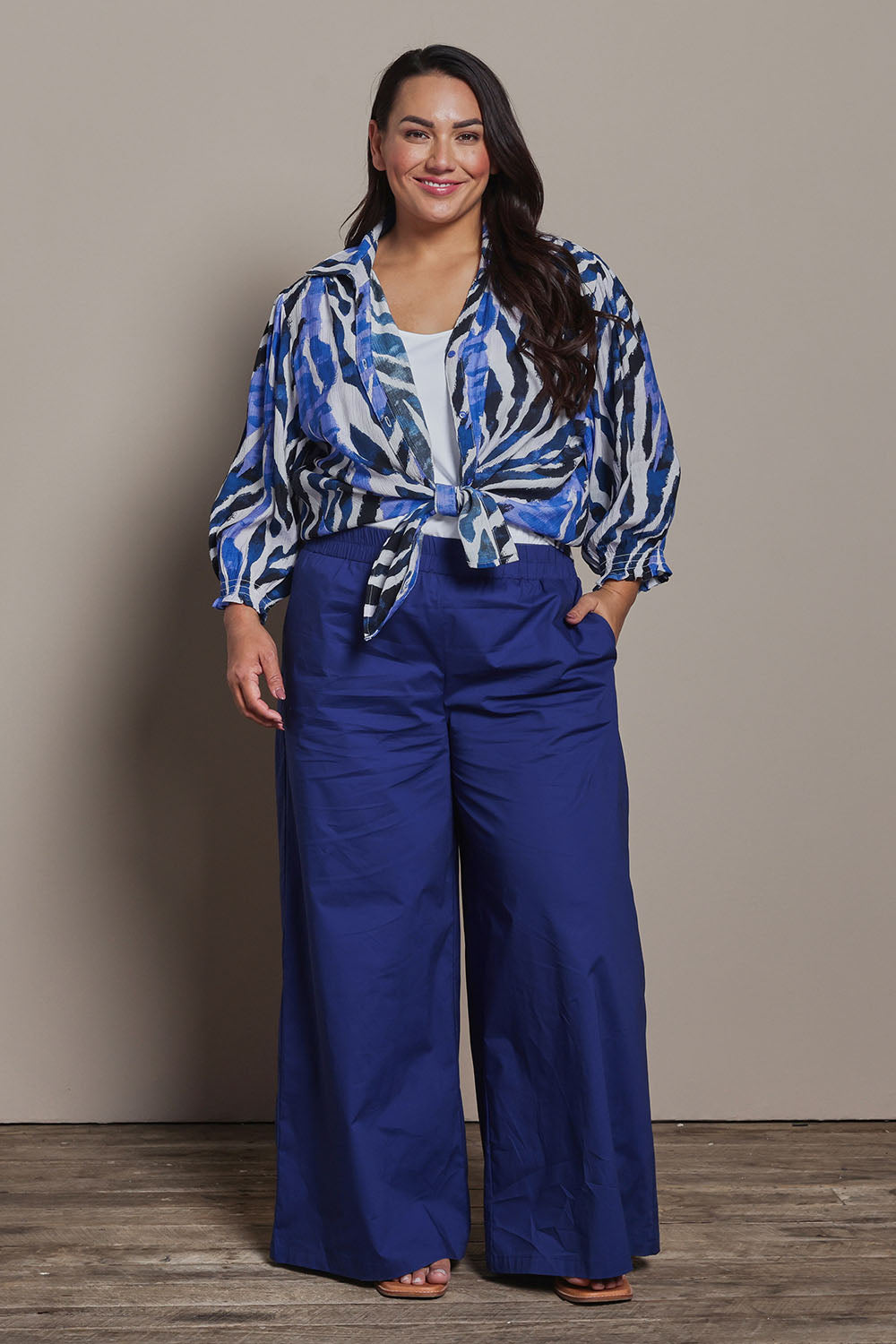 Model Ashleigh wearing size 16 of the Belle Cotton Stretch Palazzo Pant in colour Sapphire (Blue), from the front, showing the whole outfit