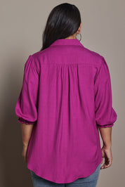 Model Ashleigh wearing size 16 of the Belle Luxe Shirred Sleeve Shirt in colour Magenta (Pink), from the back