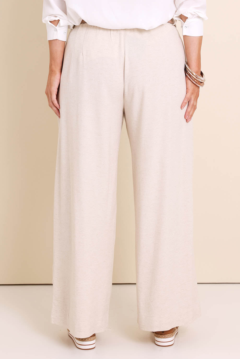Model Lauraw wearing size 14 of the Belle Wear Anywhere Pants – Sand in colour Sand, from the back