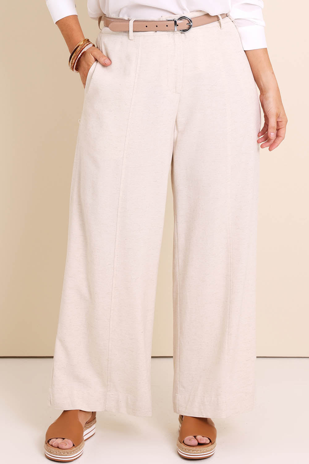 Model Lauraw wearing size 14 of the Belle Wear Anywhere Pants – Sand in colour Sand, in a cropped view