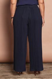 Model Ashleigh wearing size 16 of the Belle Crinkle No Iron Wide Leg Pant in colour Darknavy (Blue), from the back