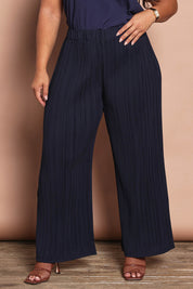 Model Ashleigh wearing size 16 of the Belle Crinkle No Iron Wide Leg Pant in colour Darknavy (Blue), from the front, cropped image