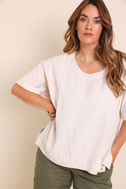 Model Lauraw wearing size 14 of the Belle Wear Anywhere Woven Tee  - Sand in colour Sand, from an angle