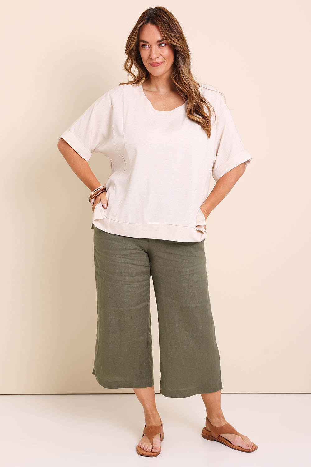 Model Lauraw wearing size 14 of the Belle Wear Anywhere Woven Tee  - Sand in colour Sand, from the front