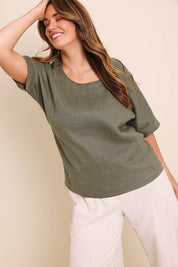 Model Lauraw wearing size 14 of the Belle Easy Wear Linen Scoop Tee – Olive in colour Olive, from an angle