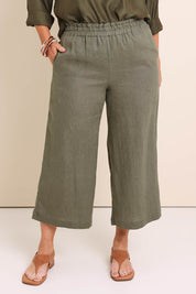 Model Lauraw wearing size 14 of the Belle Easy Wear Linen Pant – Olive in colour Olive, in a cropped view