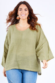 Model Laura wearing size 14 of the Sheer Delight Linen Knit Throw Top in colour Olive (Green), from the front, cropped image
