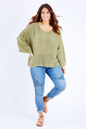 Model Laura wearing size 14 of the Sheer Delight Linen Knit Throw Top in colour Olive (Green), from the front, showing the whole outfit