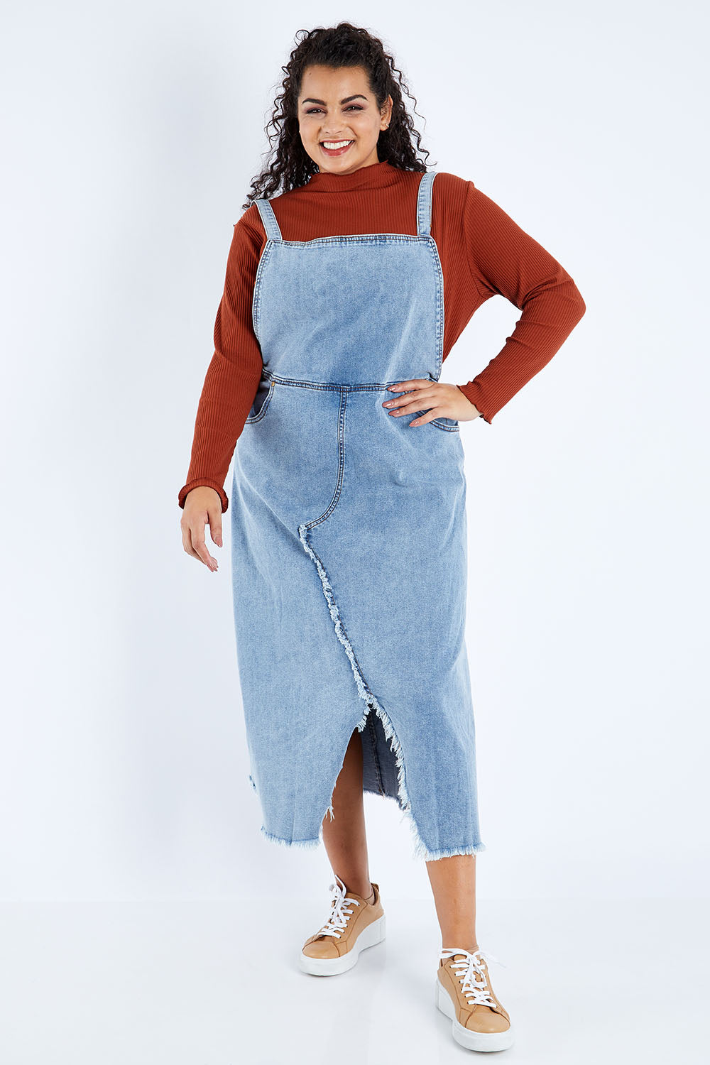 Model Sasha-Lee wearing size 16 of the Happy Me Denim Pinny in colour Denim (Blue), from the front, showing the whole outfit