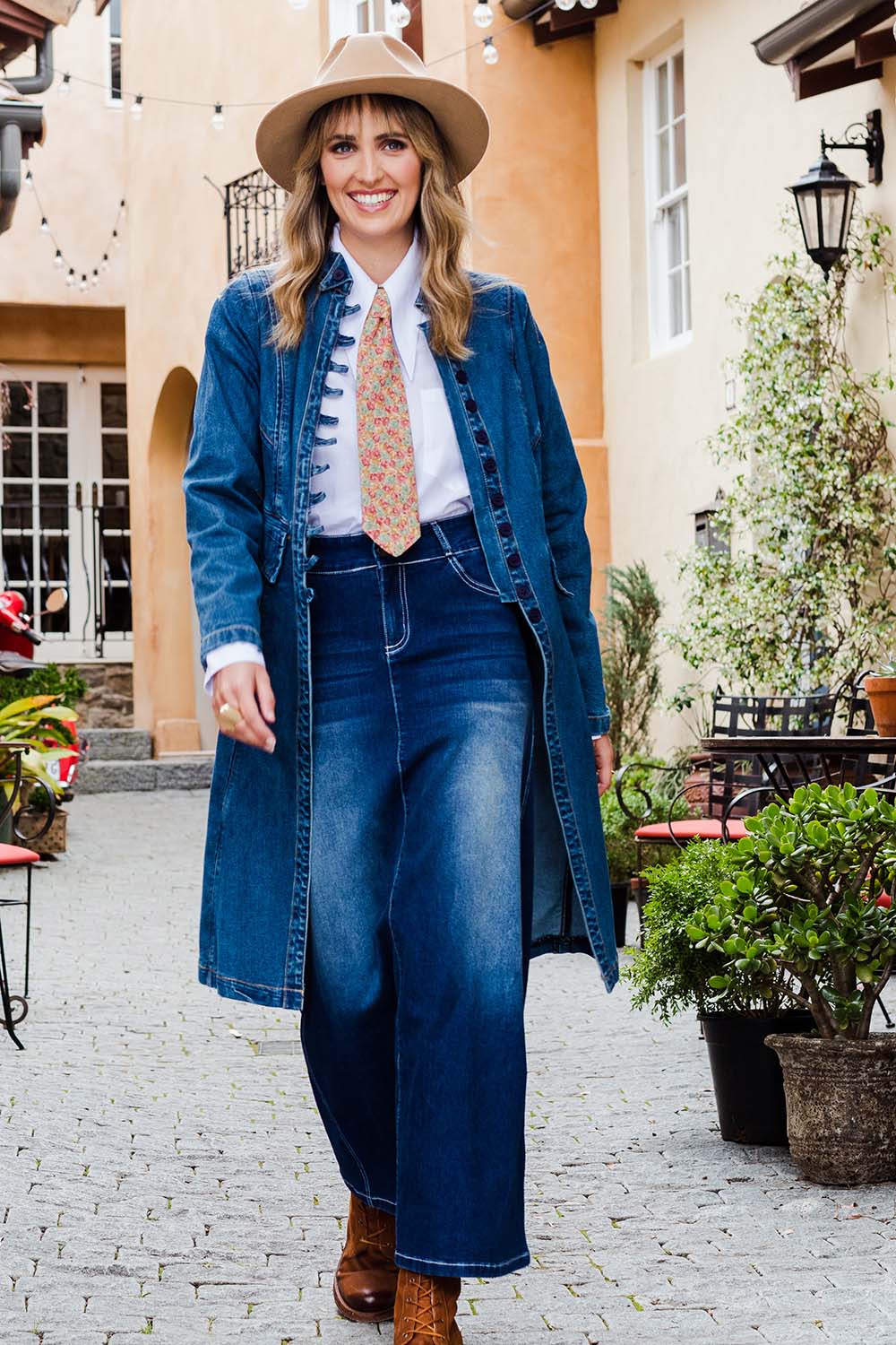 Model Tegan wearing size 10 of the Attention To Me Denim Jacket in colour Denim (Blue), from the front, showing the whole outfit